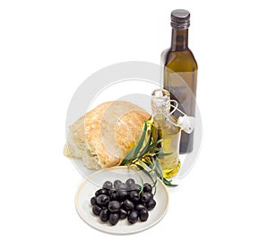 Black olives, olive oil, olive branch and ciabatta