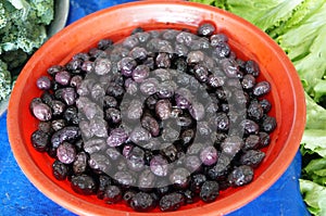 Black olives in a red plate