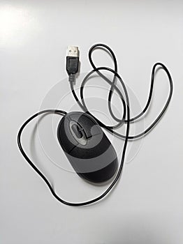 A black optical computer mouse on a white background