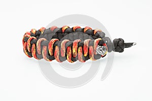 Black and orange braided bracelet on white