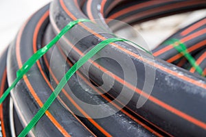 Black and orange pipe coil at construction site