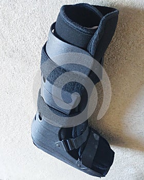 A black Orthopedic or medical boot, cast or footwear