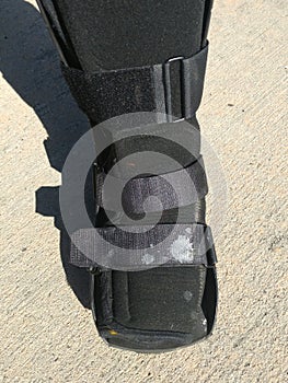 A black Orthopedic or medical boot, cast or footwear