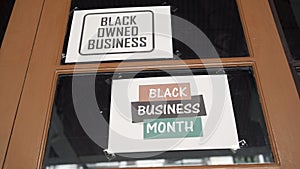 Black owned business and black business month sign were attached on the window