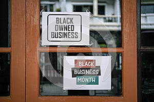 Black owned business and black business month sign were attached on the window