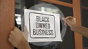 Black owned business sign were attached on the window