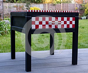 Black painted bedside table with drawer that has been upcycled and painted in Annie Sloan chalk paint.