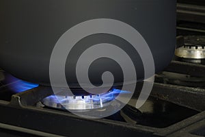 A black pan cooking on natural gas