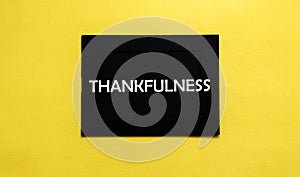 Black pancel write a text Thankfulness on the yellow