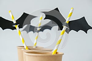 Black paper bat on drinking straw. Halloween party decoration. DIY for children craft. Autumn october holiday photo