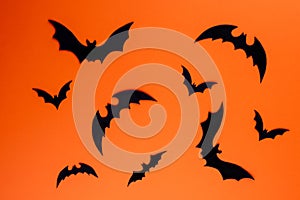 Black paper bats on horizontal orange background