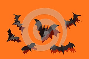 Black paper bats orange background decoration Halloween