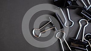 a black paper clip on a black background