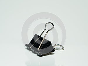 Black paper clip isolated on white background.