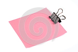 Black Paper clip and pink paper isolated on white background