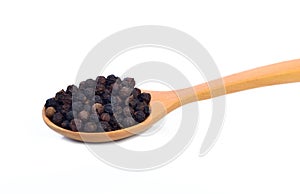 Black papper in spoon isolate on white background