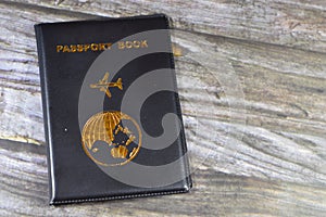 Black passport book with a plane and the globe earth on its cover, travel and tourism concept, universal passport book to protect