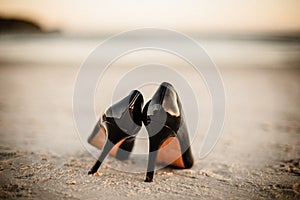 Black patent shoes at beach