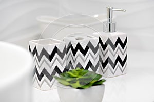 Black patterns on white toothbrush holders and soap dispensers