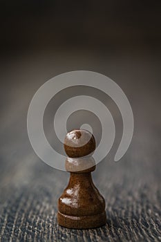 Black Pawn, Chess Piece on a Wooden Table