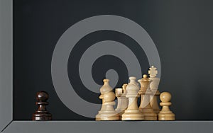 A black pawn is standing out of a group of white chess pieces