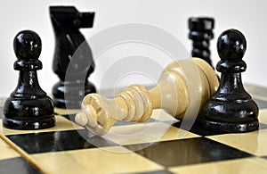 The black pawns defeated white queen on chess board