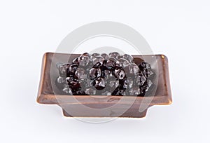 Black pearls. Boiled tapioca pearls for bubble tea on white background.