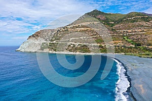 The black pebble beach of Nonza, in the Mediterranean island of Corsica. Long black beach is result of pollution from the abandone