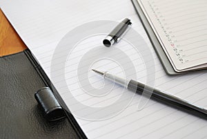 Black pen on blank writing pad