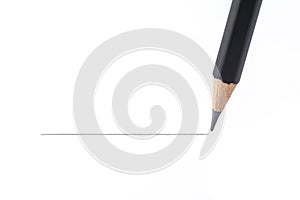 Black pencil drawing a straight line, isolated on white background