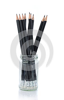 Black Pencil in empty glass jar isolated on whtie background photo