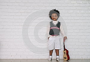 Black people African American child hold ukulele and look at camera with smile