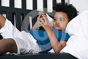 Black people African American child play smart phone at home