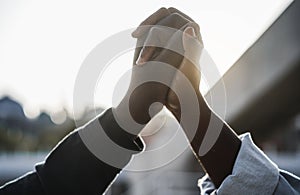 Black people holding hands during protest for no racism - Empowerment and equal rights concept