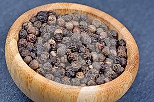 Black pepper in a bamboo bowl