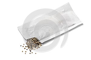 Black pepper from a disposable sachet on white background close up