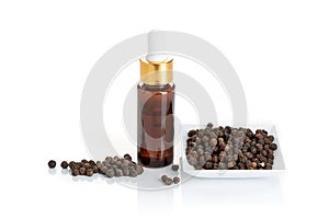 Black pepper essential oil isolated on white background