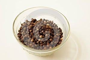 Black pepper on glass bowl