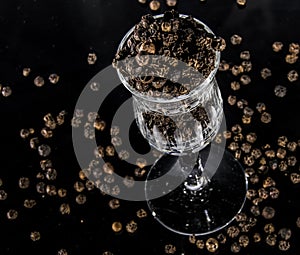 Black pepper in glass with dark background