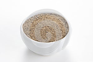 Black pepper ground in a bowl on white background