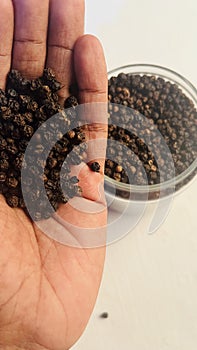 black pepper in hand photo