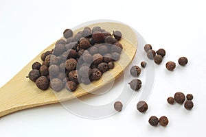 Black pepper peas on a wooden spoon