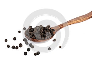 Black pepper peas in wooden spoon on white background.