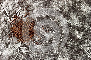 Black pepper seeds pile on black and white background. Top view. Close up