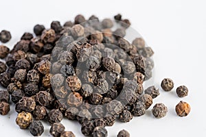 Black pepper seeds on a white background