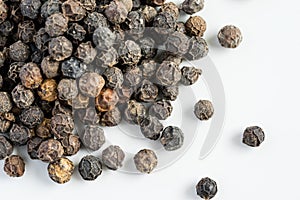 Black pepper seeds on a white background