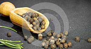 Black pepper on wooden spoon