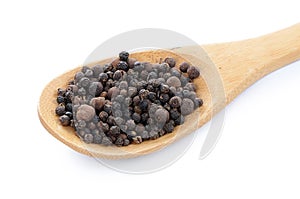 Black pepper in a wooden spoon