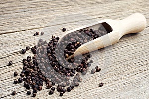 Black pepper in wooden spoon