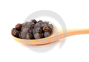 Black pepper in wooden spoon solated on white
